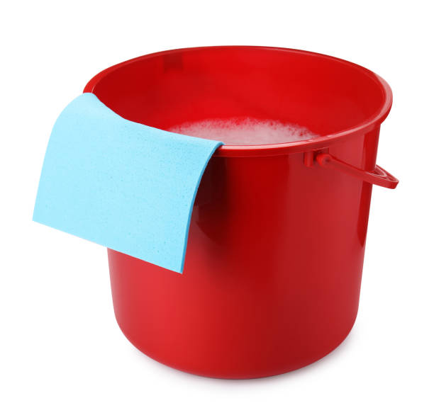 istock Red bucket with detergent and rag isolated on white 1471736987