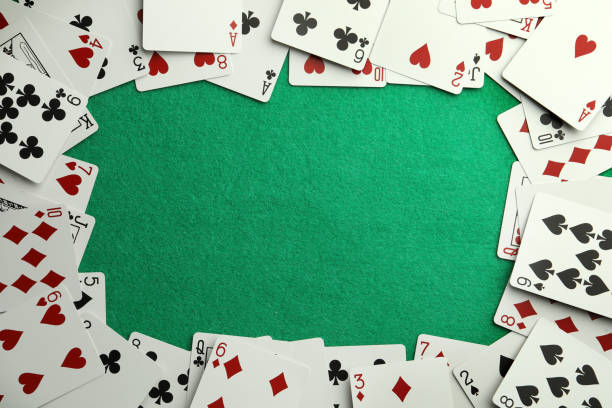 istock Frame made of playing cards on green table, top view. Space for text 1471737131