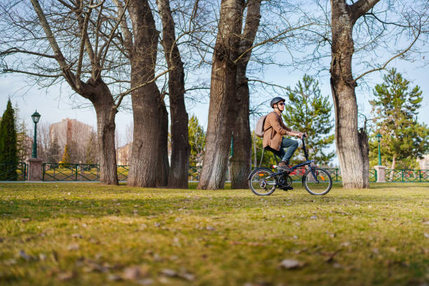 istock Man wearing helmet, riding bicycle in park. 1471739522
