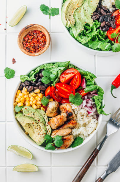 istock Mexican chicken burrito bowl with rice, beans, tomato, avocado,corn and lettuce. 1471741378
