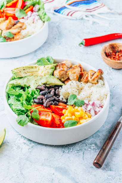 istock Mexican chicken burrito bowl with rice, beans, tomato, avocado,corn and lettuce. 1471741394