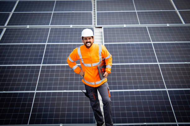 istock Portrait of solar panel engineer standing inside sustainable energy power plant. 1471743600