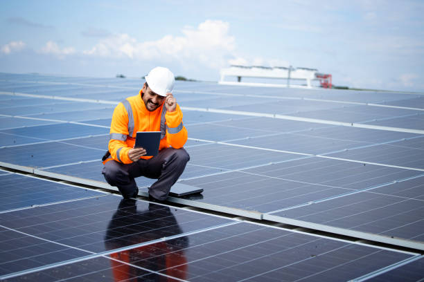 istock Solar energy worker or engineer with his laptop computer checking installation and productivity of new solar power plant. 1471744258