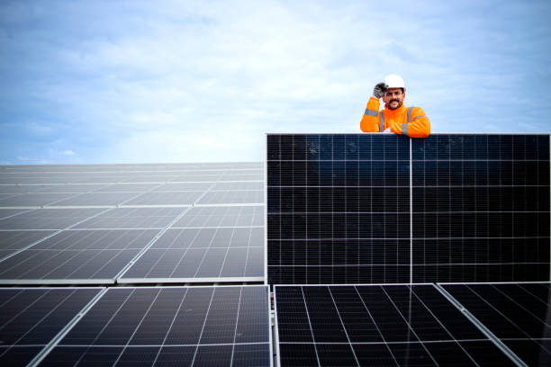 istock Portrait of worker holding solar panel inside power plant. 1471744342