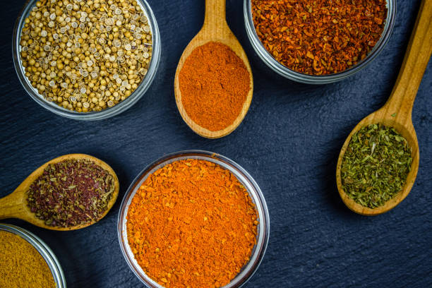 istock Spoons and bowls with oriental spices on a slate board. Top view 1471744397