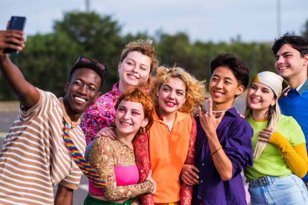 istock Group of teenagers having a fun time outdoors together 1471750663