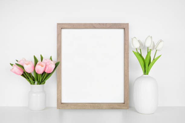 istock Mock up wood frame with spring tulip flowers. White shelf against a white wall. Copy space. 1471753723