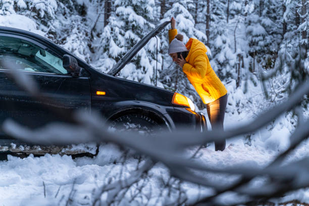 istock Winter car breakdown, woman calls for help. 1471761855