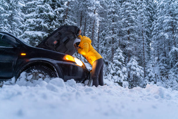 istock Winter car breakdown, woman calls for help. 1471761860