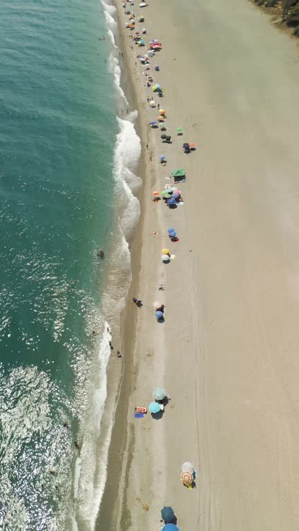 Aerial view of people on the beach in summertime, Sicily, Italy.