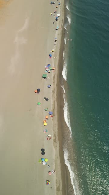 Aerial view of people on the beach in summertime, Sicily, Italy.