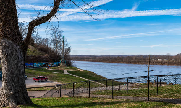 Brandenburg, Kentucky, USA February 25, 2023 Steps leading down to a park and a parking lot along the Ohio River along with the Confederate Veteran's Monument on a sunny winter day