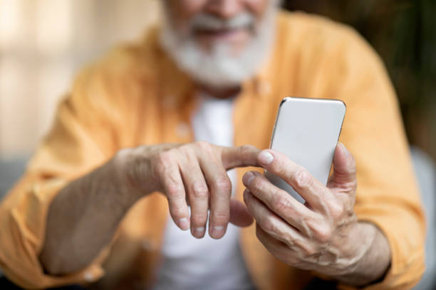 istock Cropped of senior man using smartphone at home 1471775225