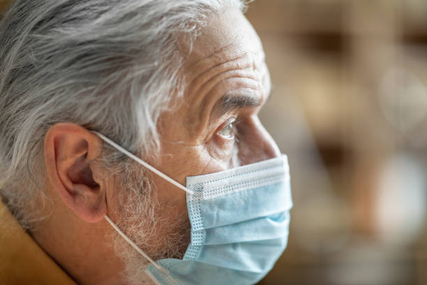 istock Closeup of senior man wearing protective face mask 1471775246