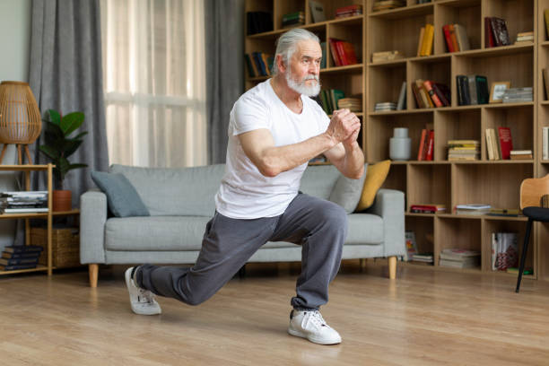istock Motivated athletic senior man doing lunges at home 1471775531