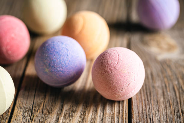 istock Multicolored bath bombs on a wooden background close-up. 1471776053
