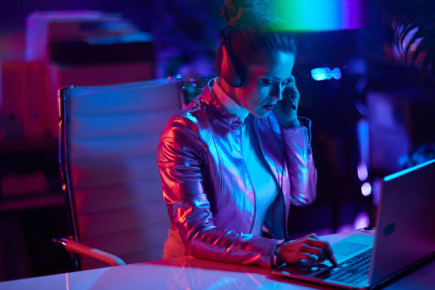 istock stylish woman with laptop and headset 1471777655