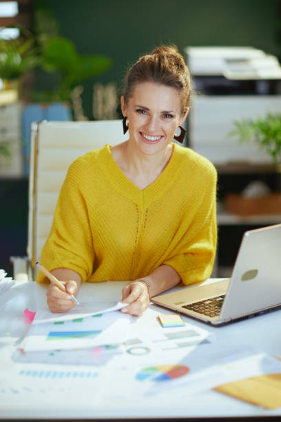 istock business owner woman in green office working with documents 1471778172