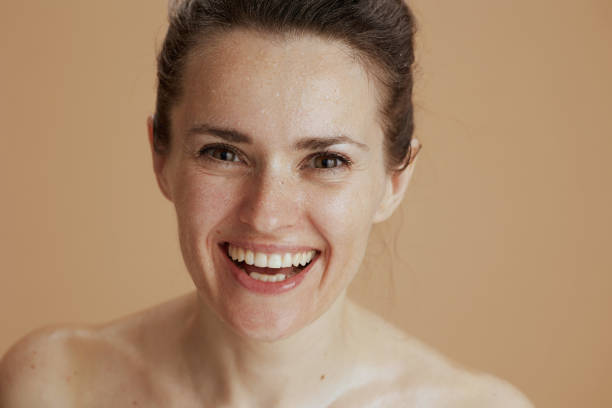 istock smiling woman with wet face washing 1471778240