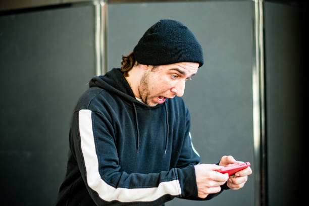 istock Excited man playing video games on mobile phone 1471778346