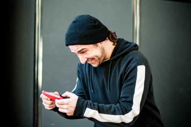 istock Excited man playing video games on mobile phone 1471778348