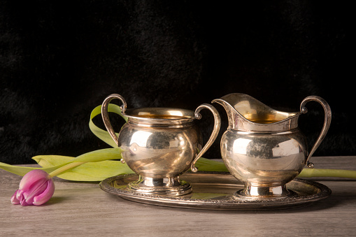 An antique sterling silver serving set with a tulip.