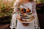 Bride holding wedding cake