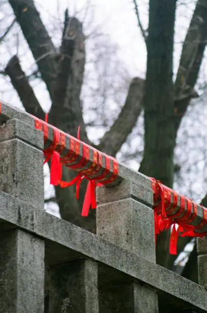 Guardrails tied with red ropes in a Chinese temple. It means people are praying to God