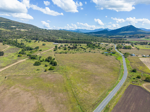 Rural farmland and country road with view of Great Dividing Range, near Boonah, Queensland