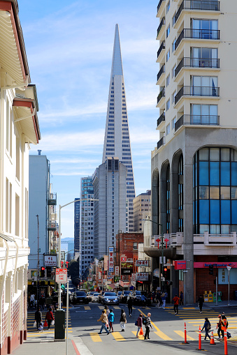 San Francisco, CA, USA - February, 19 2023: San Francisco Chinatown Street View,  Transamerica Pyramid Background.