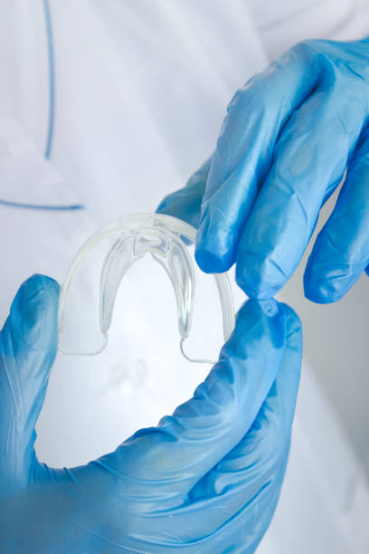 istock Teeth Whitening - Tooth Tray in doctors hand, Close-up. Invisible removable retainers for orthodontic treatment. 1471803699