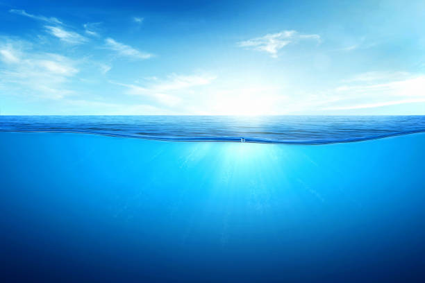 istock BLUE UNDER WATER waves and bubbles. Beautiful white clouds on blue sky over calm sea with sunlight reflection, Tranquil sea harmony of calm water surface. 1471806225