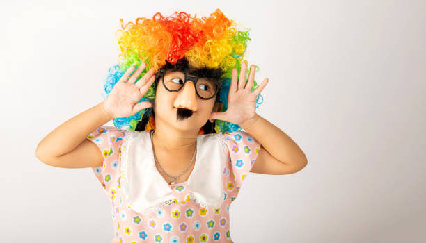 April Fool's Day April Fool's Day. Two brothers funny kid little girl clown wears curly wig colorful big nos and glasses and mustache playing fool isolated on white background copy space, Happy child festive decor april fools day stock pictures, royalty-free photos & images