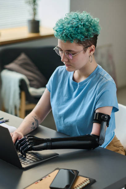 istock Woman with disability typing on laptop 1471808658