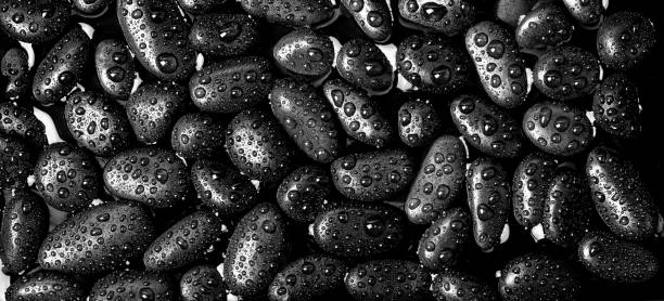 istock Black river stones texture and background. Black pebbles in water and water drop. 1471809522