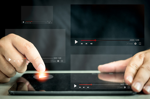 Man watching a live stream by tablet. Online live stream window. Video streaming on internet concept. Live digital stream multimedia player. Online content scrolling videos online followed
