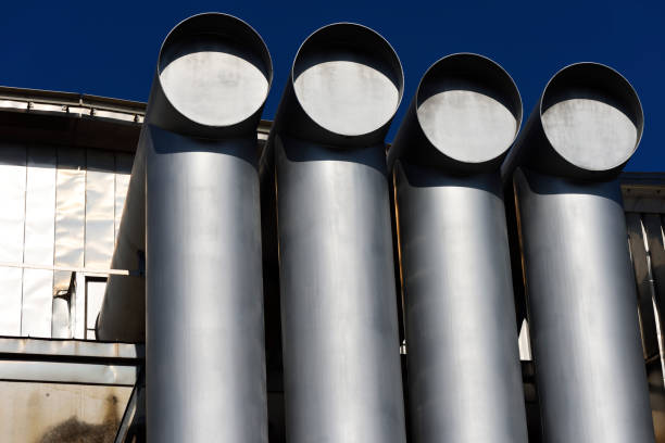 Air ducts in a large building against clear sky with copy space.