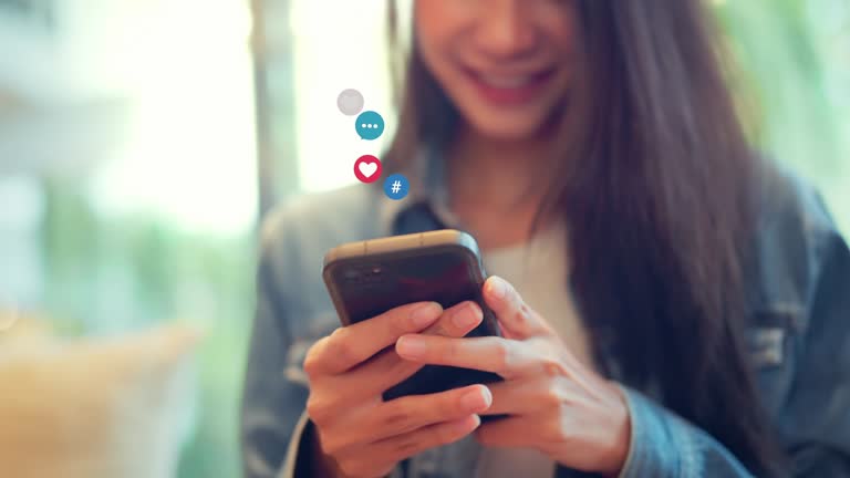 Woman hands using smartphone watching a live stream in coffee cafe, Happy young female using social media on their mobile phone.