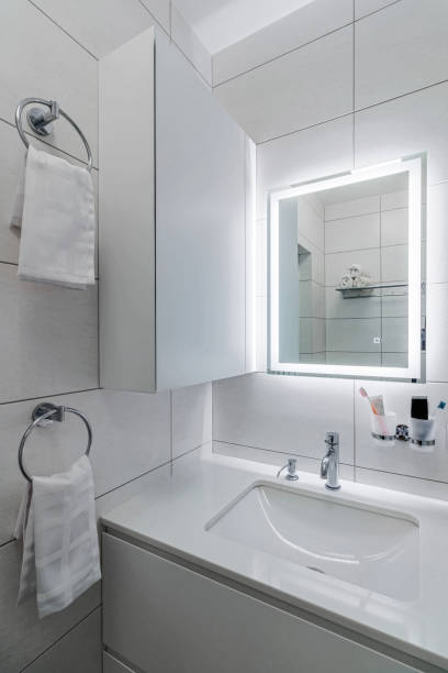 istock Modern bathroom in white washer and large mirror with backlight 1471813405