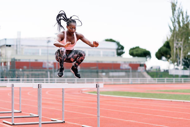 istock African-American athlete sprinter jumping a hurdle 1471815820
