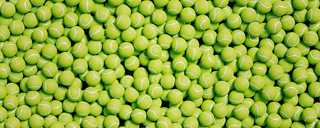 Panoramic view of bright new tennis balls background covering sport court top view