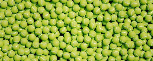 Panoramic view of bright new tennis balls background covering co Panoramic view of bright new tennis balls background covering sport court top view tennis ball stock pictures, royalty-free photos & images