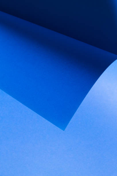 istock Monochrome composition formed by blue cardboard and the curvature it forms when folded. 1471818509