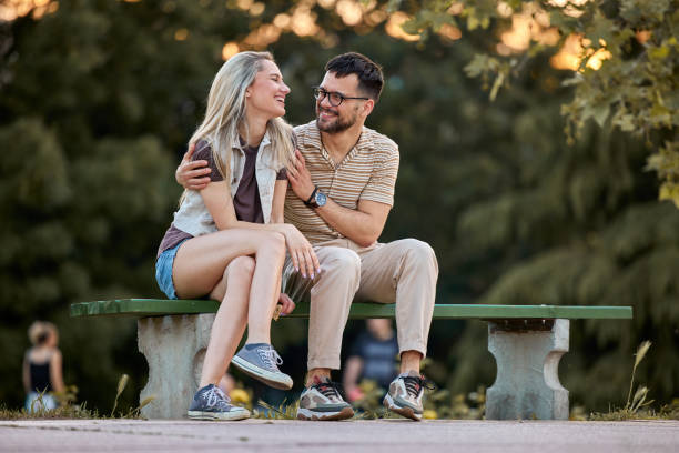 istock Happy couple talking on a park bench in nature. 1471819167