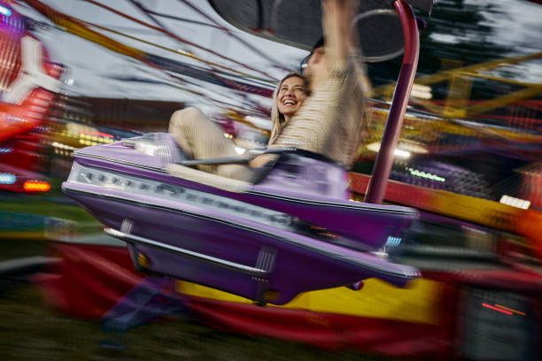 Villach, Austria - July 30, 2025: Amusement ride at Villacher Kirchtag festival features joyful riders experiencing the thrill of spinning high above the ground
