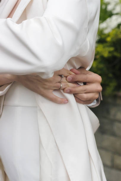 istock Young married couple holding hands, ceremony wedding day 1471820021