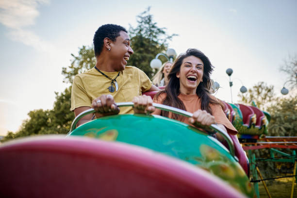 istock Young cheerful couple having fun on rollercoaster at amusement park. 1471820030