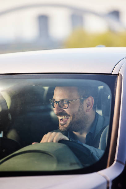 istock Young happy man going on a trip by car. 1471820224