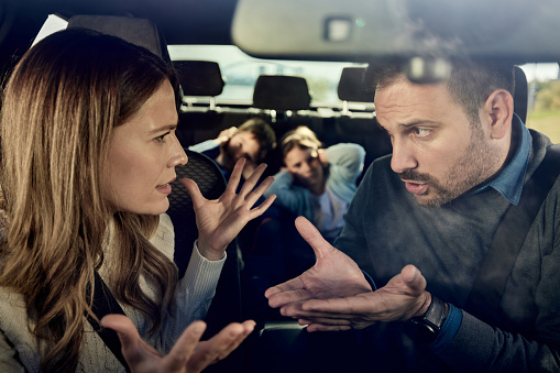 istock Frustrated parents arguing during trip by a car. 1471820394