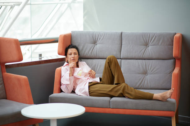 istock Young beautiful brunette woman relaxing on a couch 1471821013